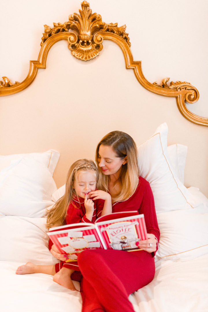 Eva Amurri Martino reads Eloise to her daughter Marlowe on a bed at the Plaza Hotel in New York City