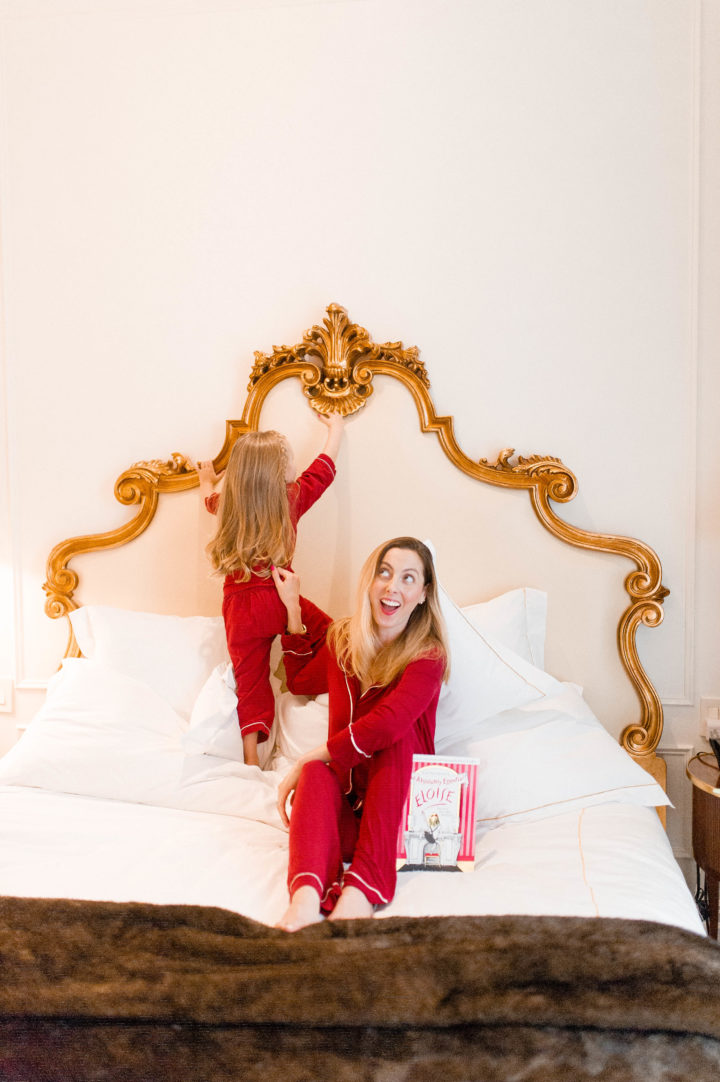 Eva Amurri Martino reads Eloise to her daughter Marlowe on a bed at the Plaza Hotel in New York City