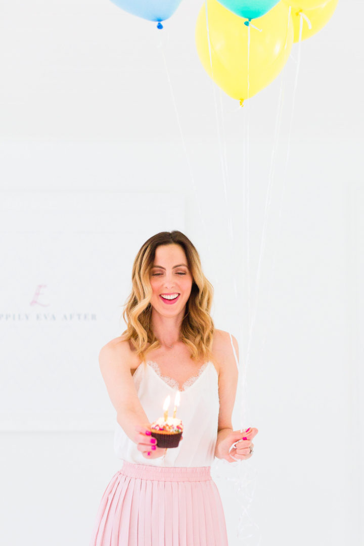 Eva Amurri Martino holds a cupcake with a candle to commemorate the 3rd birthday of her blog Happily Eva After