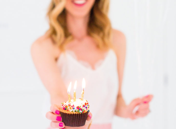 Eva Amurri Martino holds a cupcake with a candle to commemorate the 3rd birthday of her blog Happily Eva After