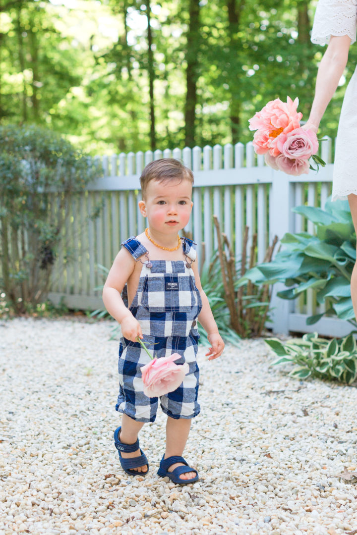 Eva Amurri Martino's son Major carries flowers from their garden in Connecticut.