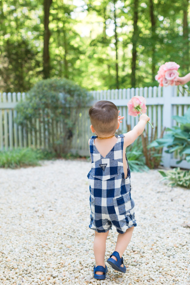 Eva Amurri Martino's son Major carries flowers from their garden in Connecticut.