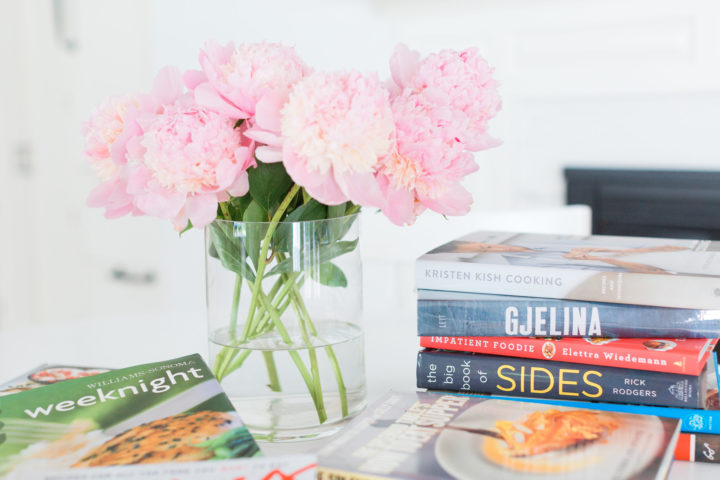 Eva Amurri Martino shares her favorite cookbooks next to a beautiful vase of peonies