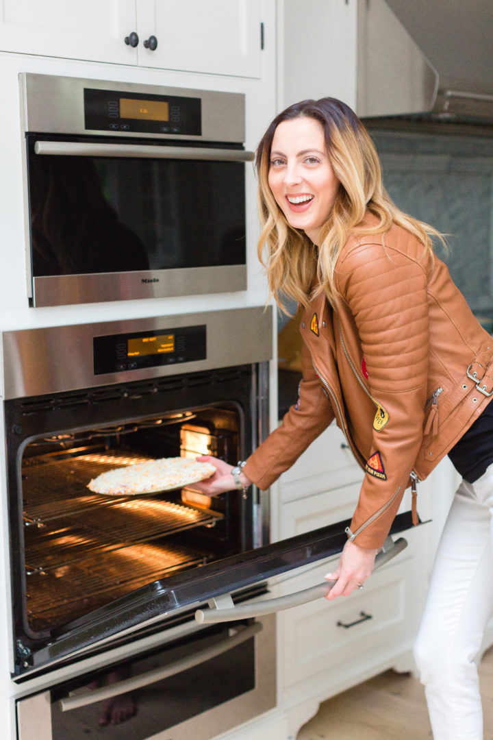 Eva Amurri Martino puts a Red Baron pizza in the oven