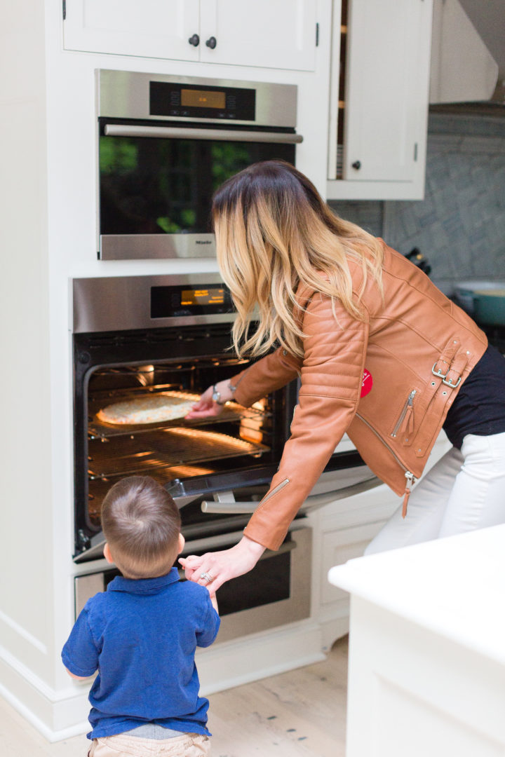 Eva Amurri Martino puts a Red Baron pizza in the oven