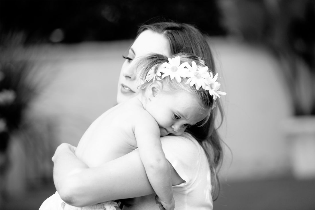 Eva Amurri Martino holds toddler daughter Marlowe in her arms in the yard of their sherman oaks home