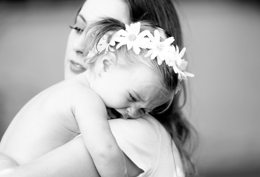 Eva Amurri Martino holds toddler daughter Marlowe in her arms in the yard of their sherman oaks home