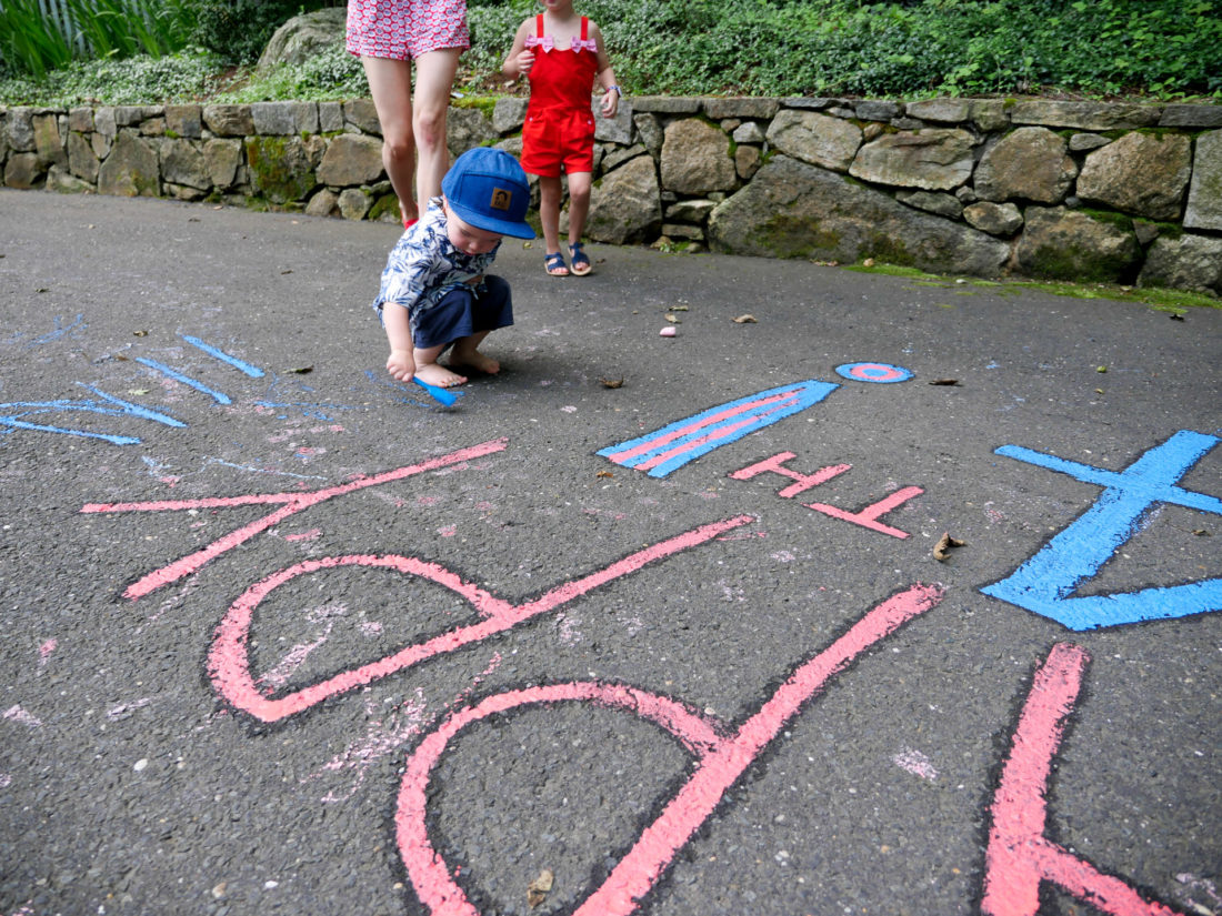 Major Martino paints with chalk paint in the driveway of his Connecticut home on the fourth of july