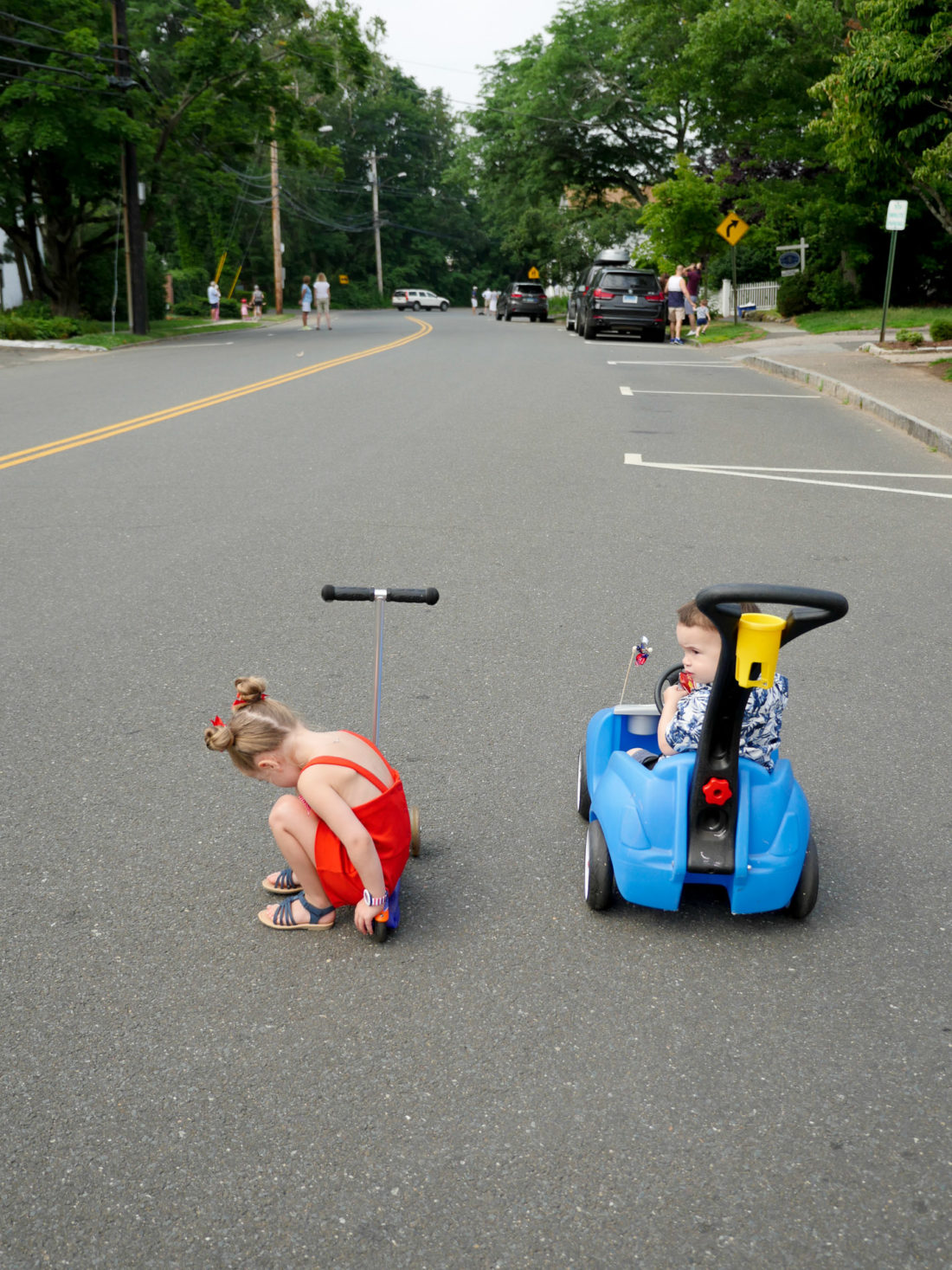 Marlowe and Major Martino ride their scooter and car on the fourth of july