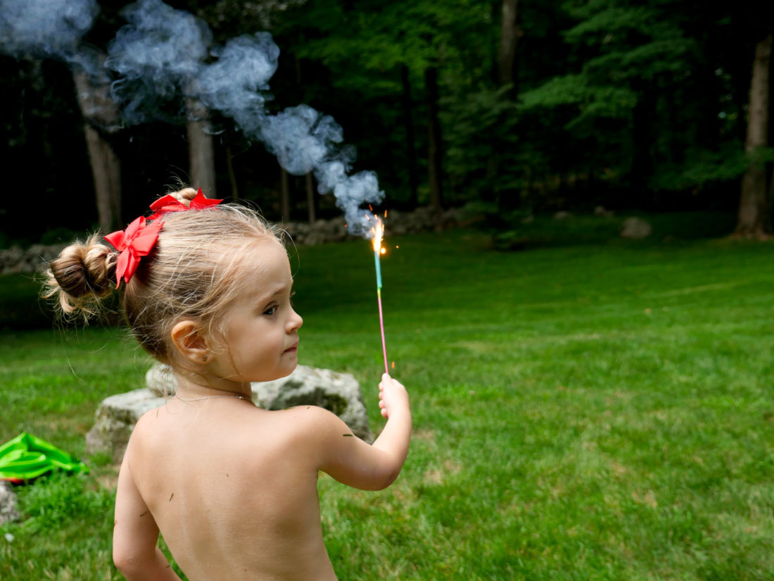 Marlowe Martino holds a sparkler on the fourth of july