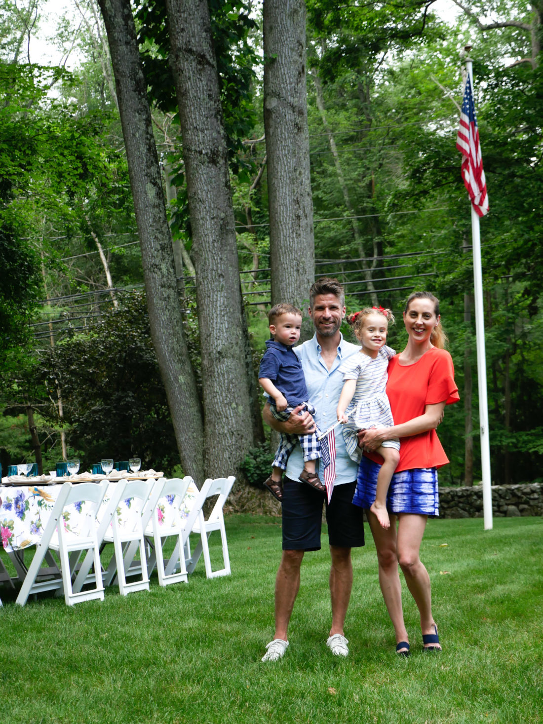 EvaAmurri Martino, Kyle Martino, Marlowe Martino, and Major Martino post together at a family fourth of july party wearing red white and blue