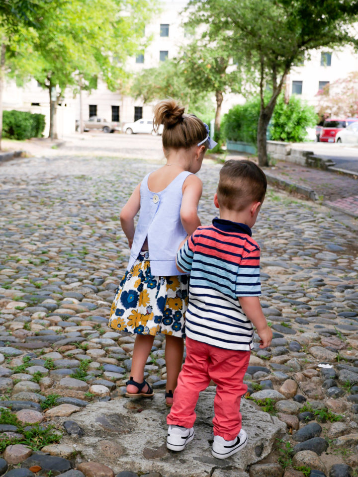 Eva Amurri Martino's kids Marlowe and Major hold hands on a cobblestone street in Charleston