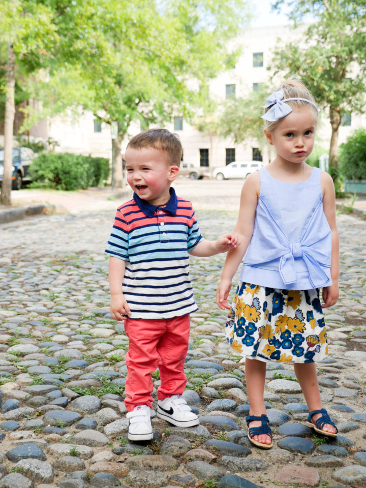 Eva Amurri Martino's kids Marlowe and Major hold hands on a cobblestone street in Charleston