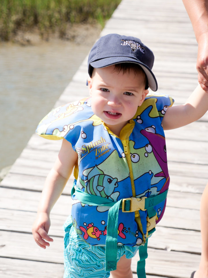 Eva Amurri Martino's son Major wears a baseball cap and a lifejacket on his way to ride on a boat with his grandparents