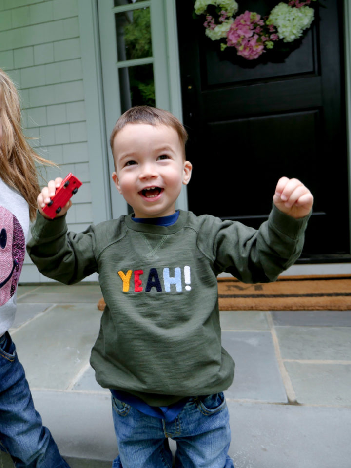 Eva Amurri Martino's son Major throws his hands in the air wearing a 'yeah!' sweatshirt