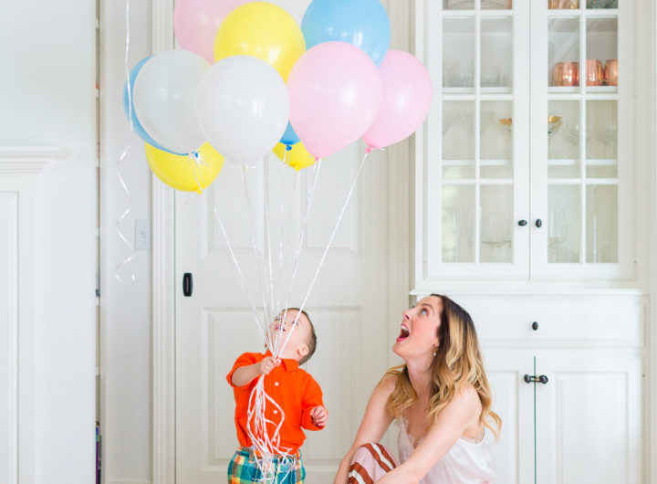 Eva Amurri Martino plays with her son Major while holding a handful of colorful balloons