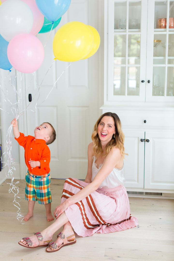Eva Amurri Martino plays with her son Major while holding a handful of colorful balloons