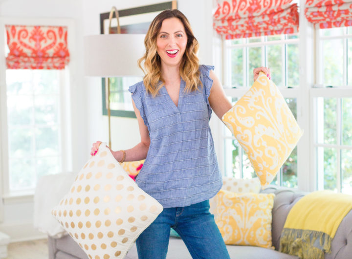 Eva Amurri Martino holds a colorful selection of pillows on her couch at her home in Connecticut