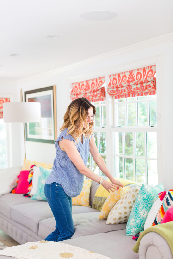 Eva Amurri Martino arranges a colorful selection of pillows on her couch at her home in Connecticut