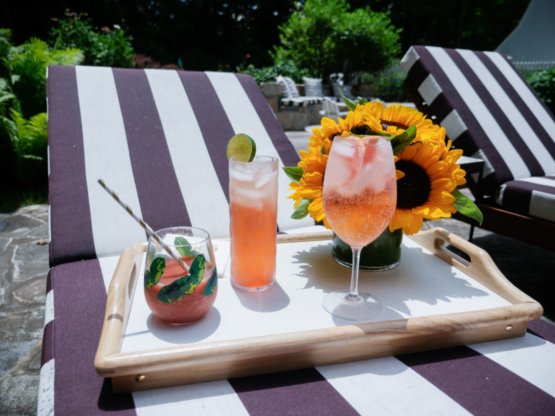 Eva Amurri Martino serves three different pink tinted cocktails to her guests poolside at her home in Connecticut