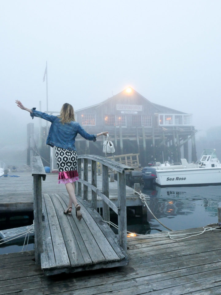 Eva Amurri Martino wears a geometric printed dress with a flare of pink and a denim jacket in Bar Harbor, ME.