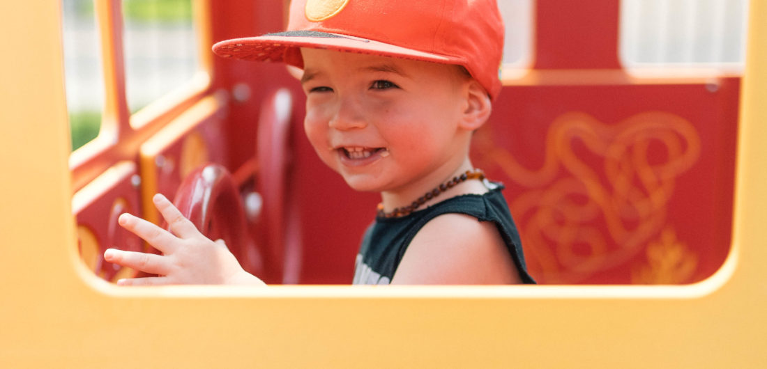 Major Martino drives in a pretend fire truck at the playground in Connecticut