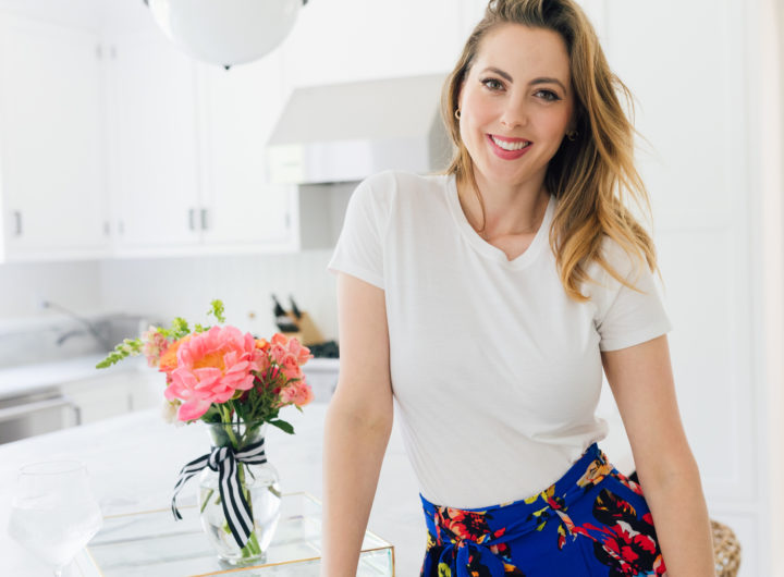 Eva Amurri Martino wears a crisp white t-shirt and a colorful skirt in her kitchen in Connecticut