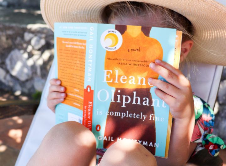 Eva Amurri Martino sits with daughter Marlowe on a chair in Amalfi reading her newest HEA Book Club pick: Eleanor Oliphant Is Completely Fine