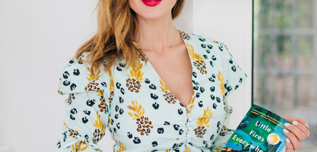 Eva Amurri Martino wears a matching Jonathan Simkhai top and shorts while holding her third HEA Book Club pick: Little Fires Everywhere by Celeste Ng