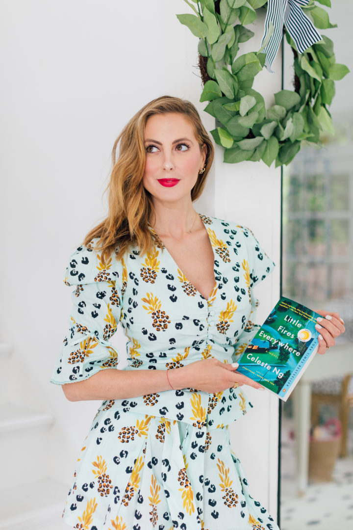 Eva Amurri Martino wears a matching Jonathan Simkhai top and shorts while holding her third HEA Book Club pick: Little Fires Everywhere by Celeste Ng