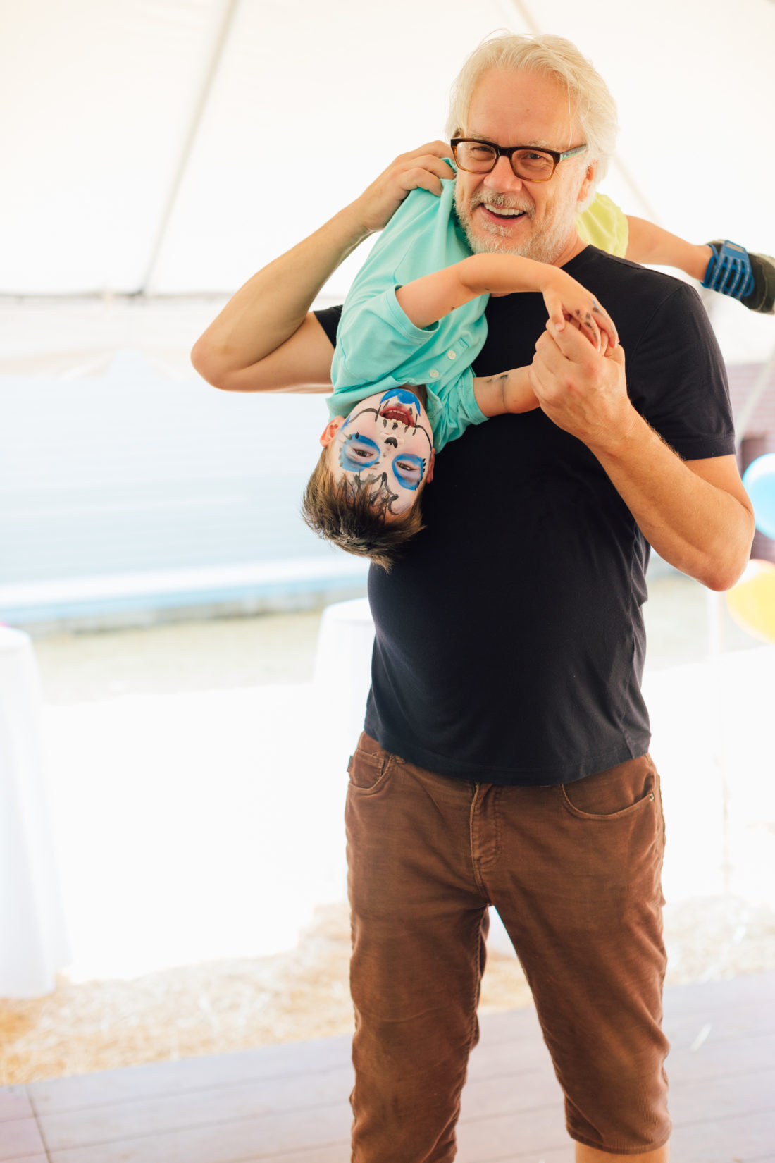 Tim Robbins holds grandson Major Martino on his shoulder at granddaughter Marlowe's Cinco de Marlowe 5th birthday fiesta