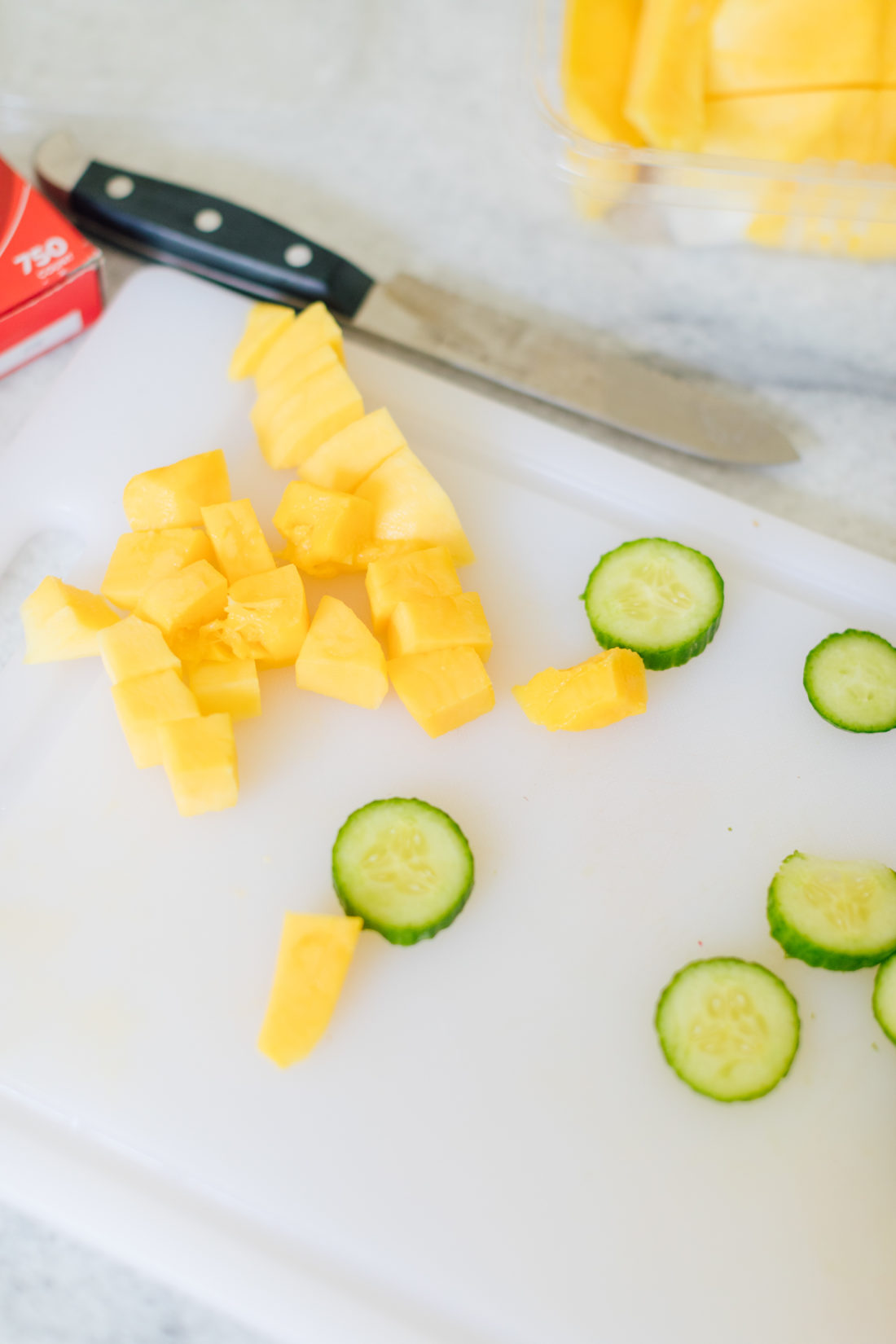 Eva Amurri Martino chops up cucumbers and fruit for an easy lunchbox meal