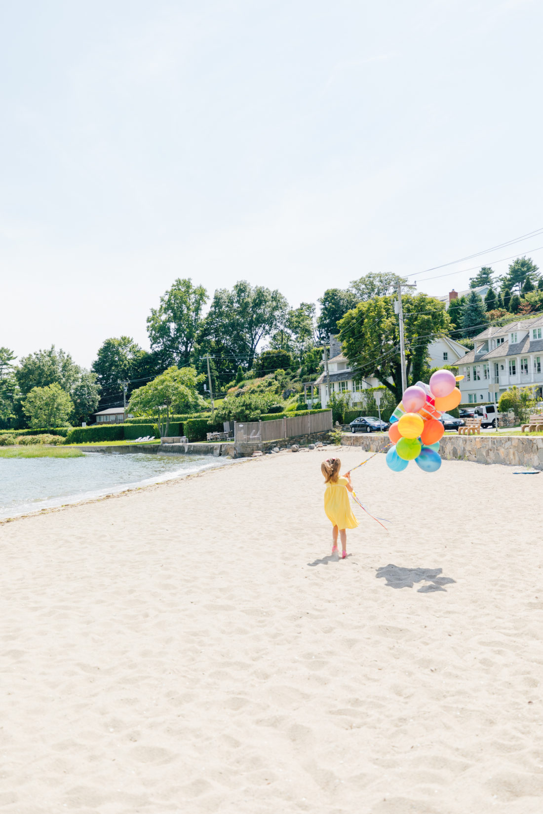 Marlowe Martino holds balloons on the beach in Connecticut to commemorate her 5th birthday