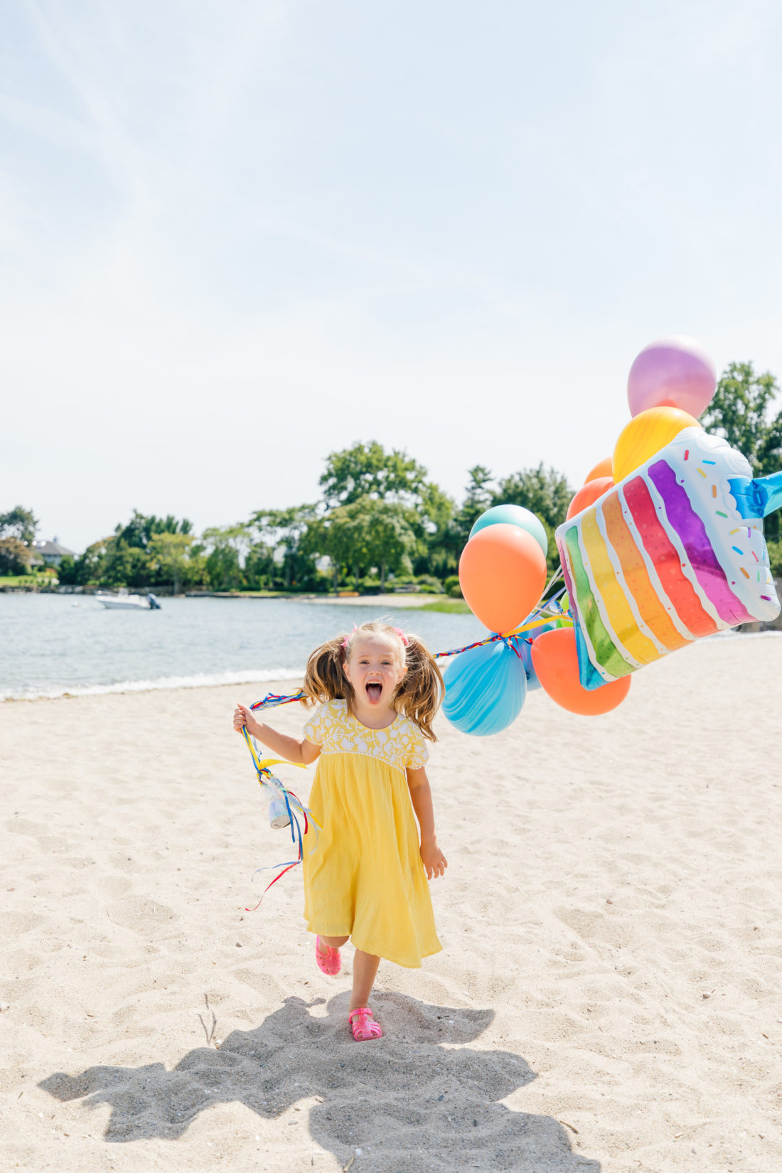 Marlowe Martino holds balloons on the beach in Connecticut to commemorate her 5th birthday