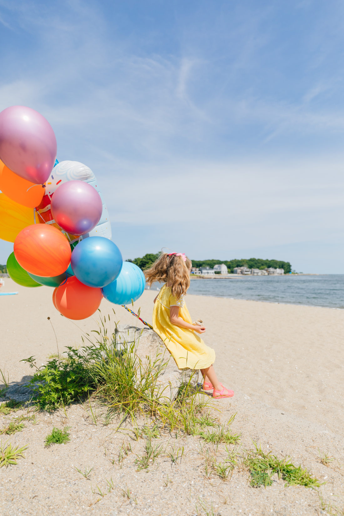 Marlowe Martino holds balloons on the beach in Connecticut to commemorate her 5th birthday