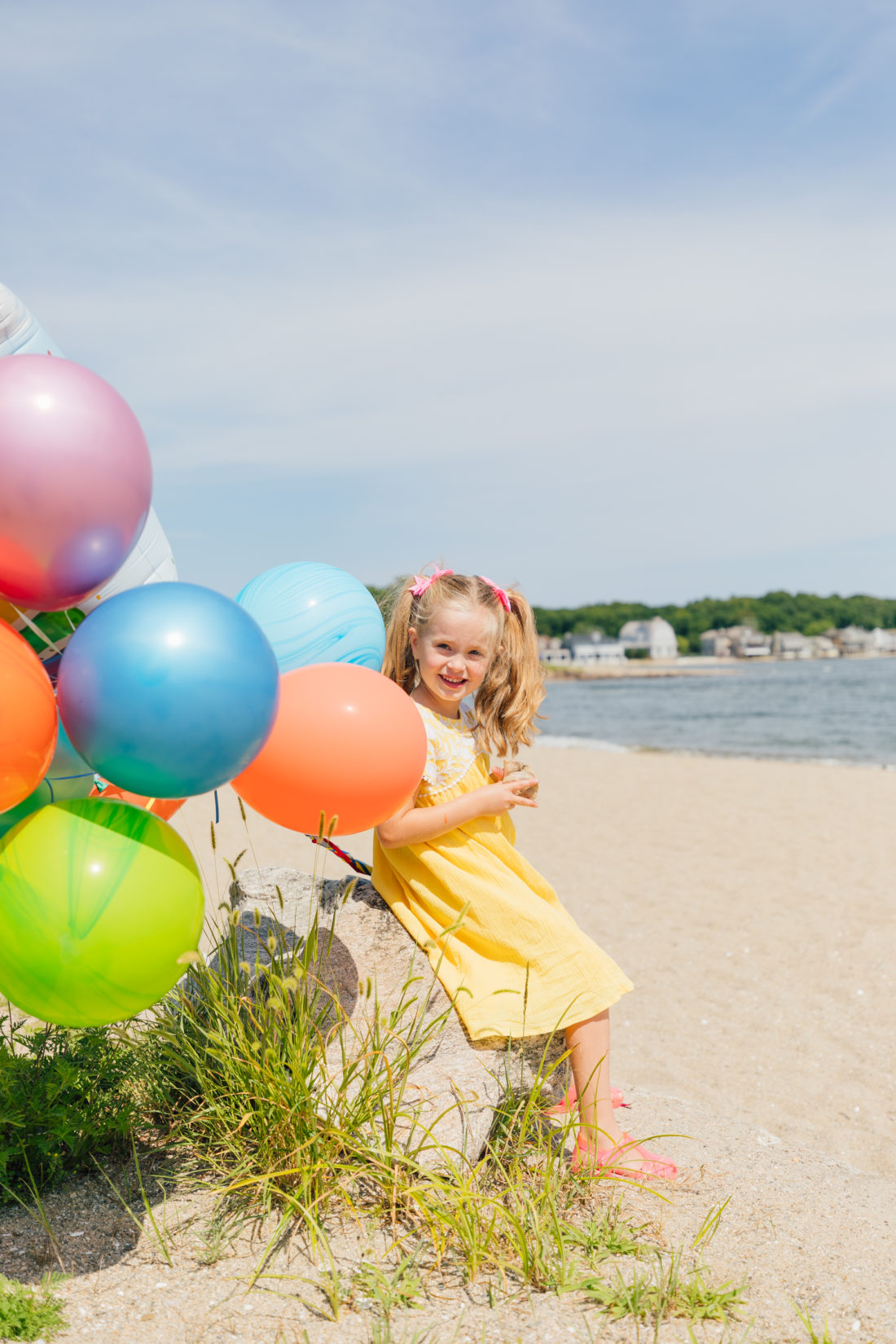 Marlowe Martino holds balloons on the beach in Connecticut to commemorate her 5th birthday