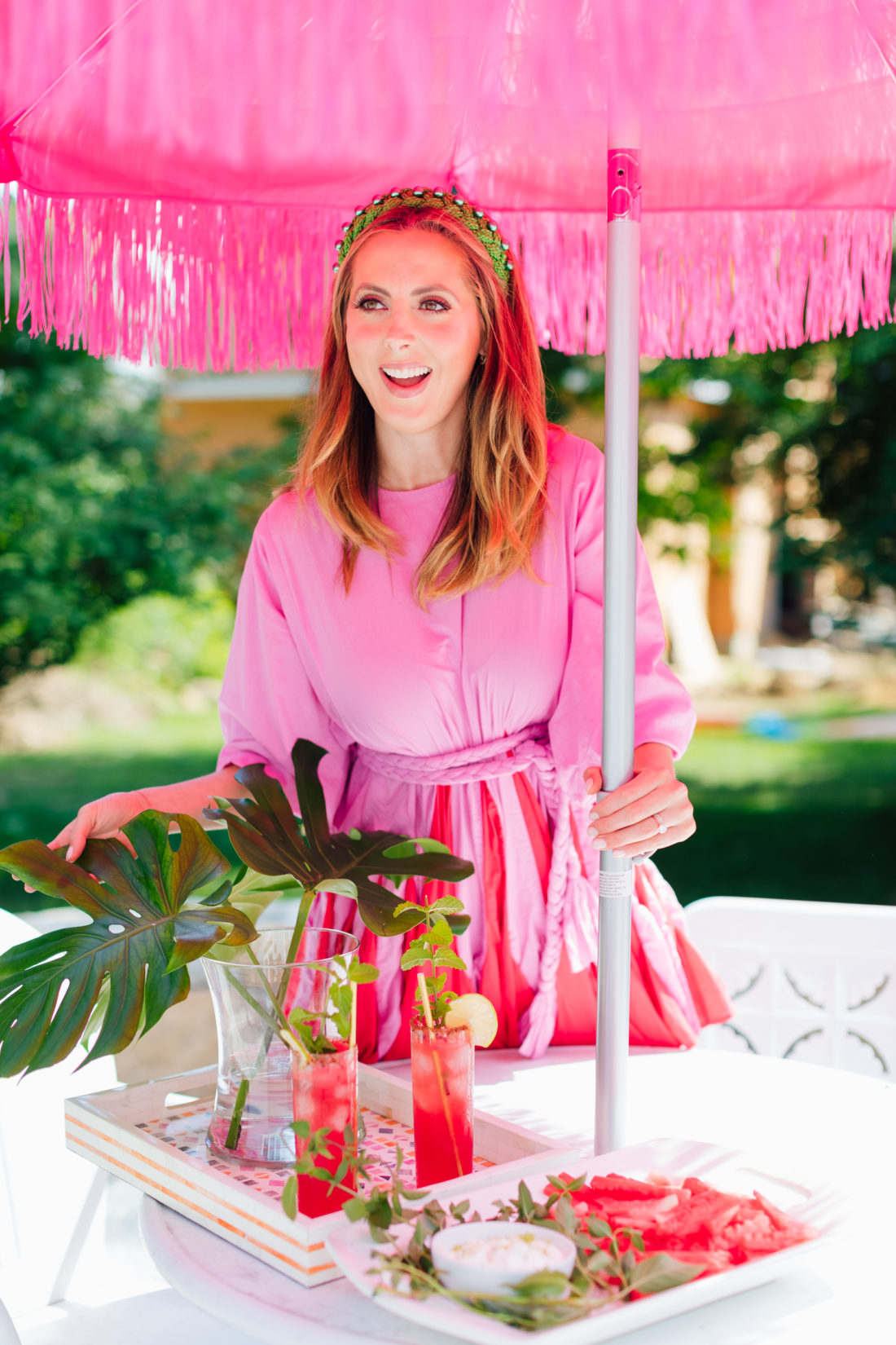 Eva Amurri Martino sets up a colorful spread outdoors underneath a pink umbrella