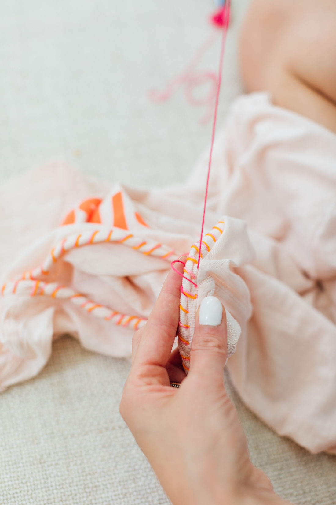 Eva Amurri Martino sewing a detail of thread on the collar of an old tee