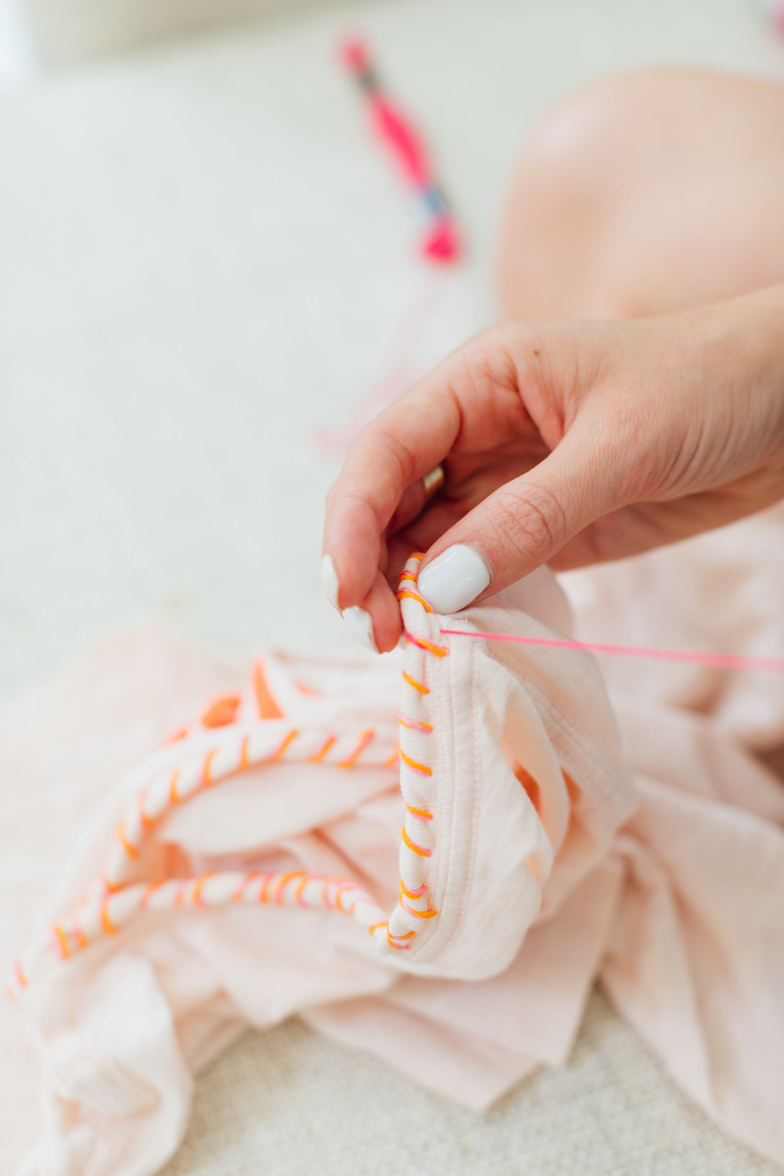 Eva Amurri Martino sewing a detail of thread on the collar of an old tee