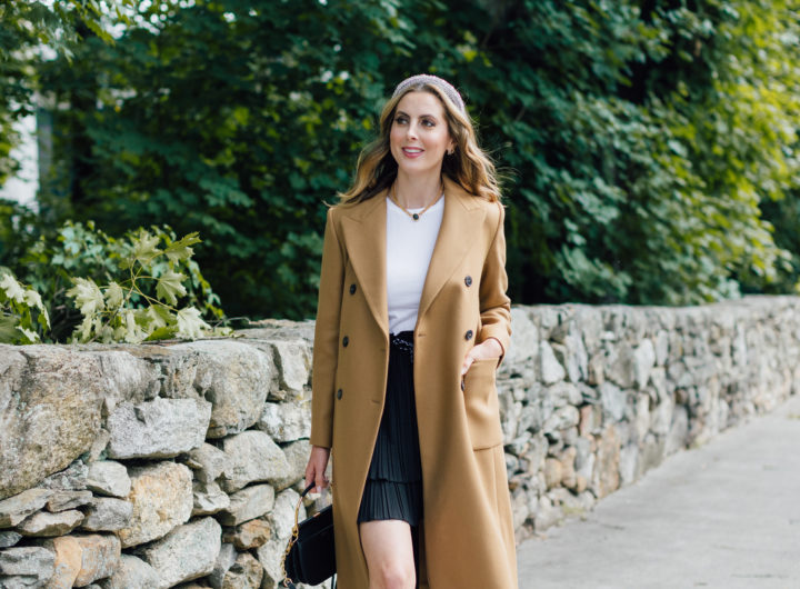 Eva Amurri Martino wears a camel coat, a black skirt and a white top as a neutral color palatte