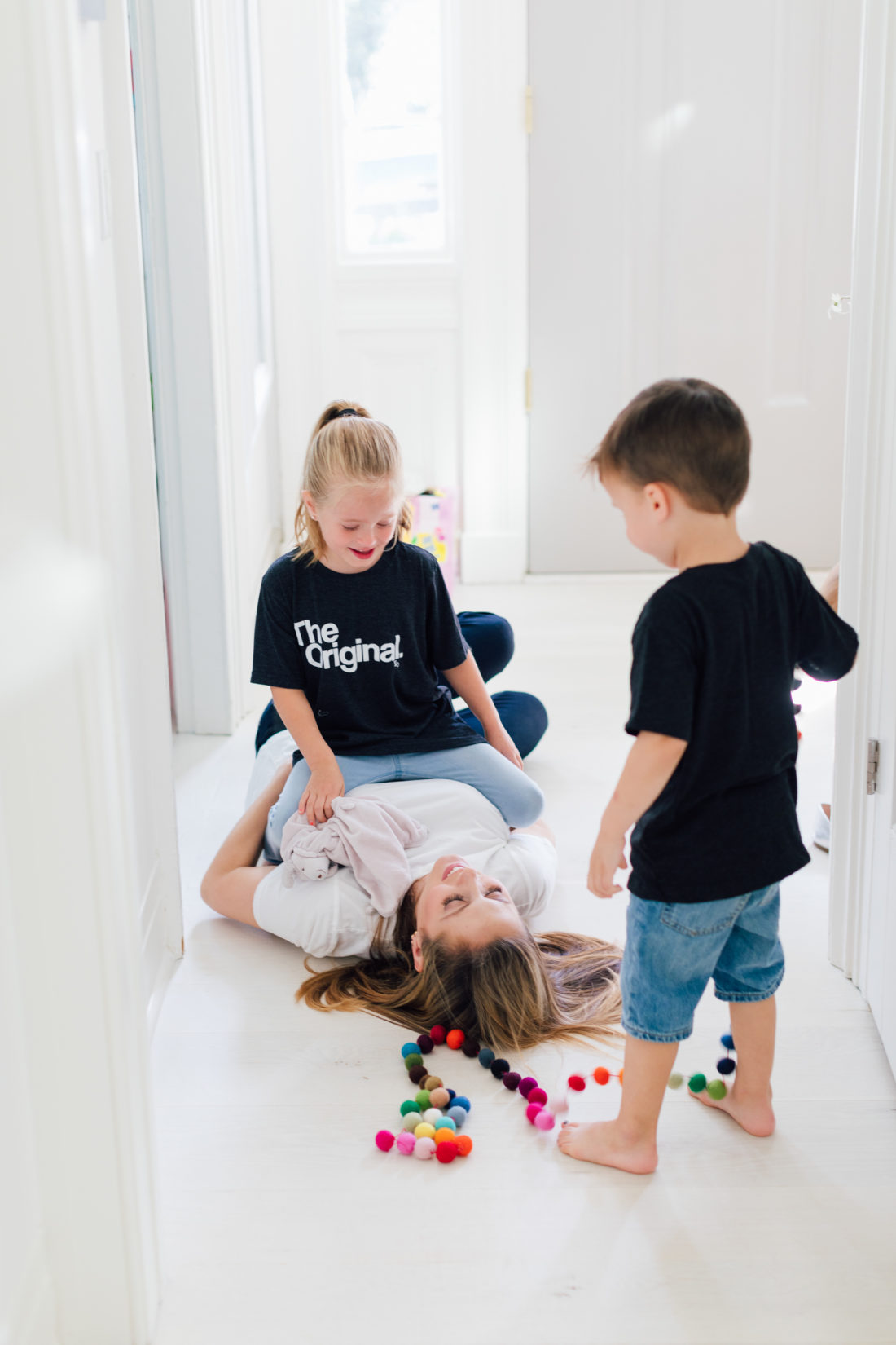 Eva Amurri Martino laughs on the floor laughing with daughter Marlowe