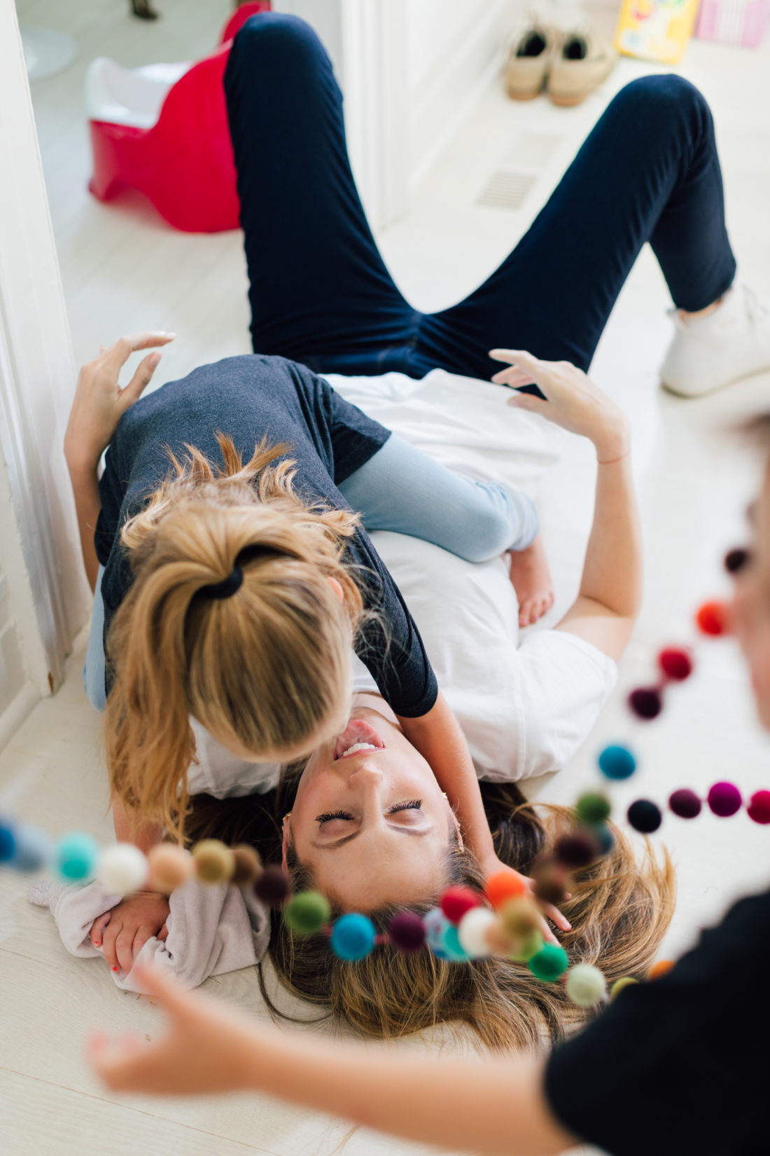 Eva Amurri Martino laughs on the floor laughing with daughter Marlowe