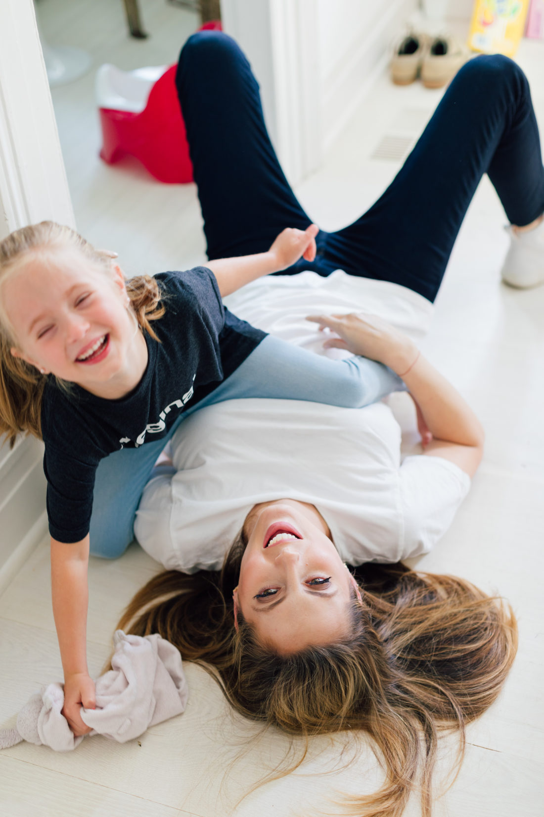 Eva Amurri Martino laughs on the floor laughing with daughter Marlowe
