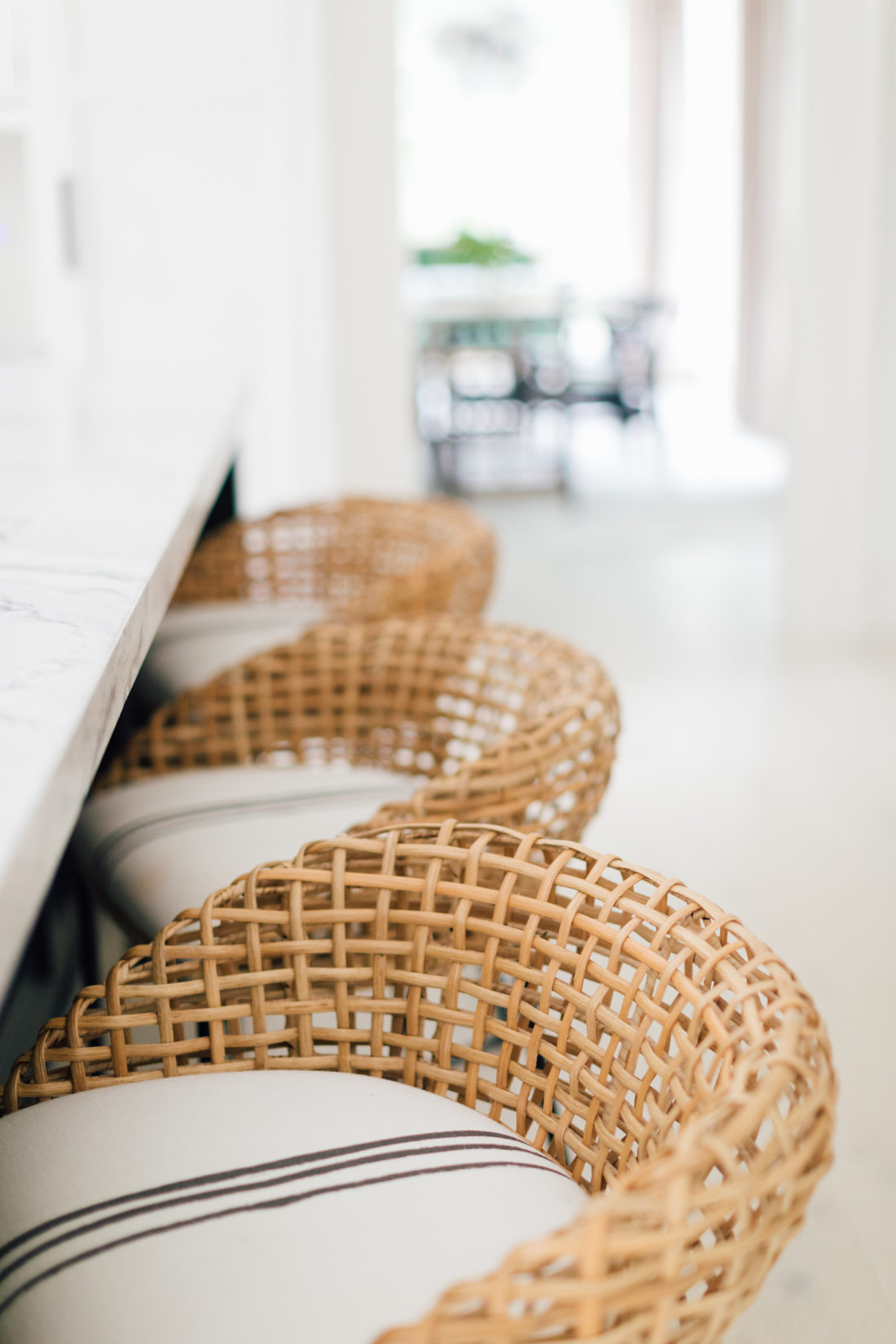 A closeup shot of the woven bar stools and the kerri rosenthal fabric on the bar stools in Eva Amurri Martino's Connecticut kitchen