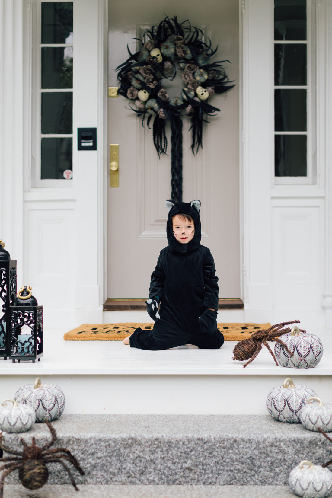 Major Martino wears a cat costume and sits on the front porch of his Connecticut home