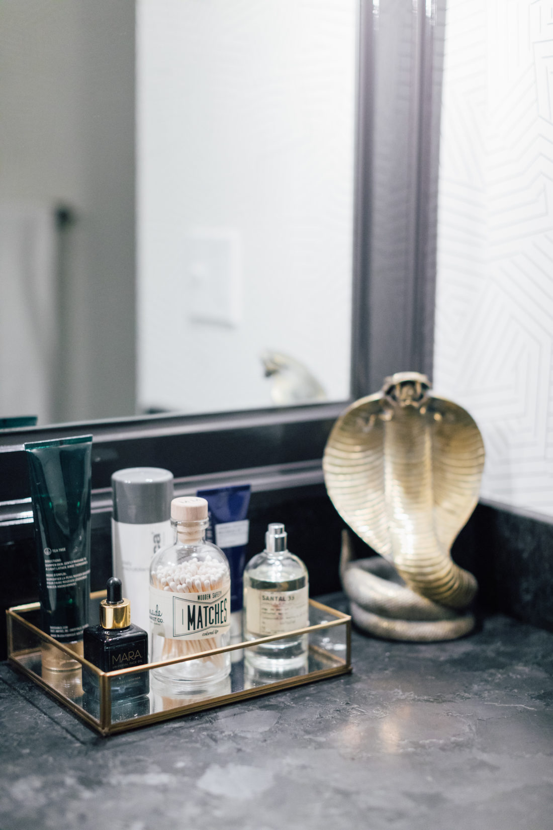 The Saint Henry Black granite countertop from Polycor inside Kyle Martino's masculine bathroom in his newly renovated Connecticut home