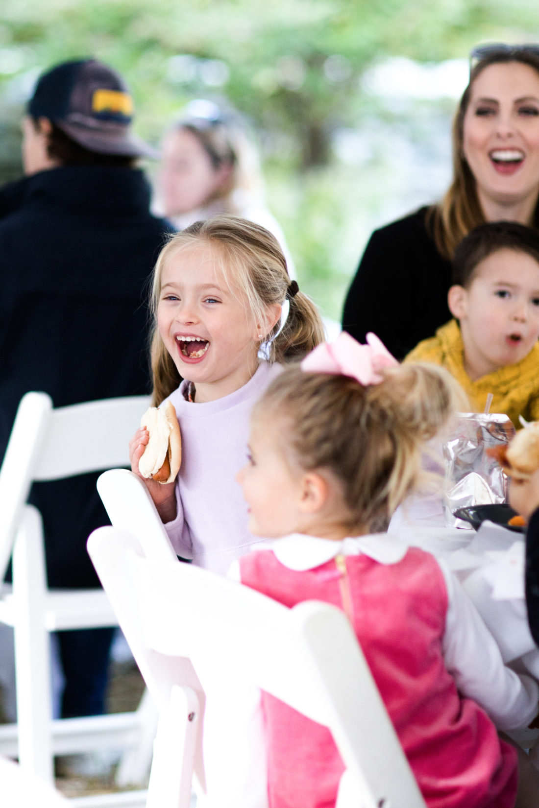 Marlowe Martino laughs while eating a hot dog at brother Major's Construction Zone themed birthday party