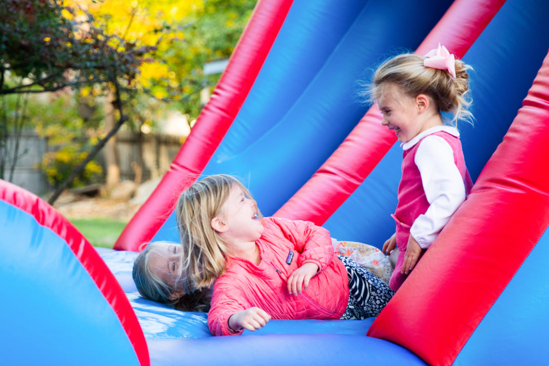 Marlowe Martino and friends slide down the side of the Bounce House at brother Major's Construction Zone themed birthday party