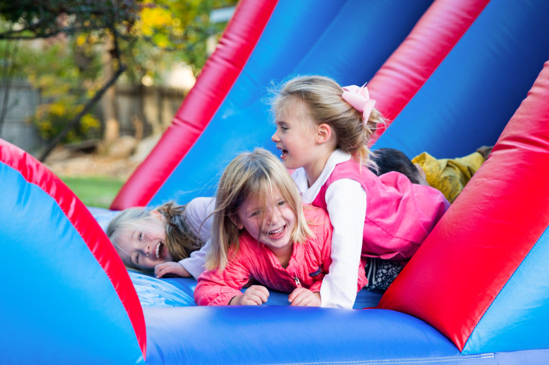 Marlowe Martino and friends slide down the side of the Bounce House at brother Major's Construction Zone themed birthday party