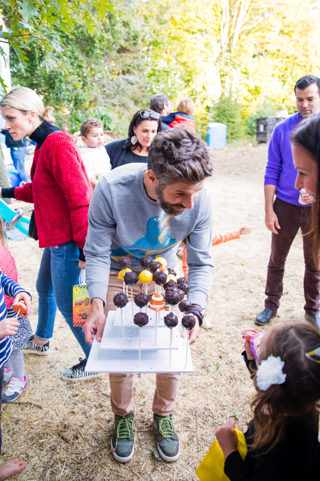 Kyle Martino offers partygoers Cake Pops at his son Major's Construction Zone themed birthday party